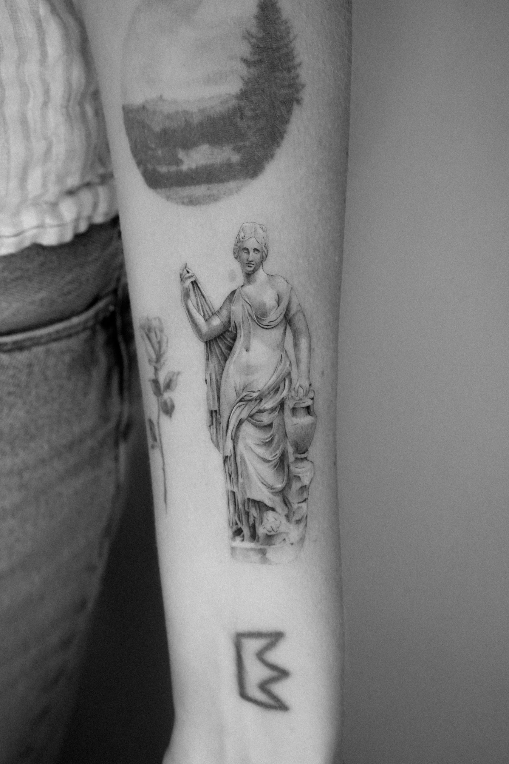 Fine line Aphrodite statue tattoo done by Kane Navasard in Los Angeles.